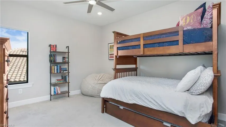 Carpeted bedroom with ceiling fan