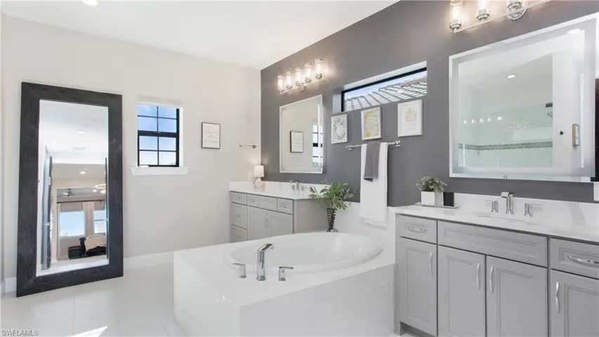 Bathroom with tile patterned floors, vanity, and shower with separate bathtub