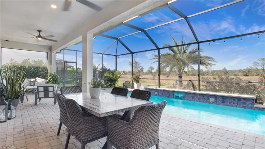 View of pool featuring ceiling fan, a lanai, and a patio