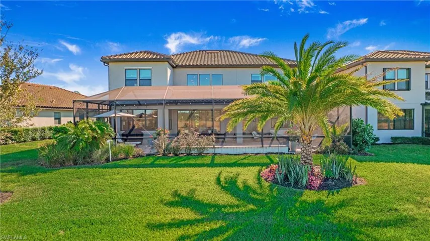 Rear view of house with a lawn