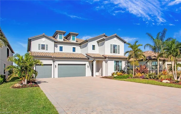 Mediterranean / spanish house with a front yard and a garage