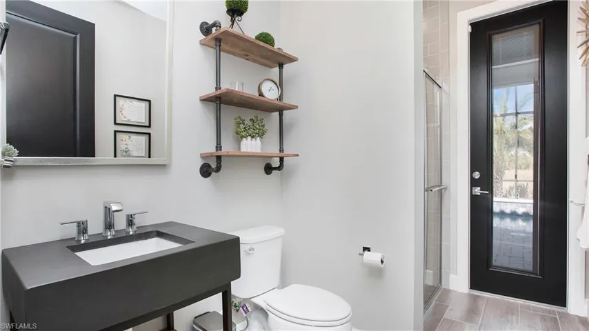 Bathroom with vanity, toilet, and walk in shower