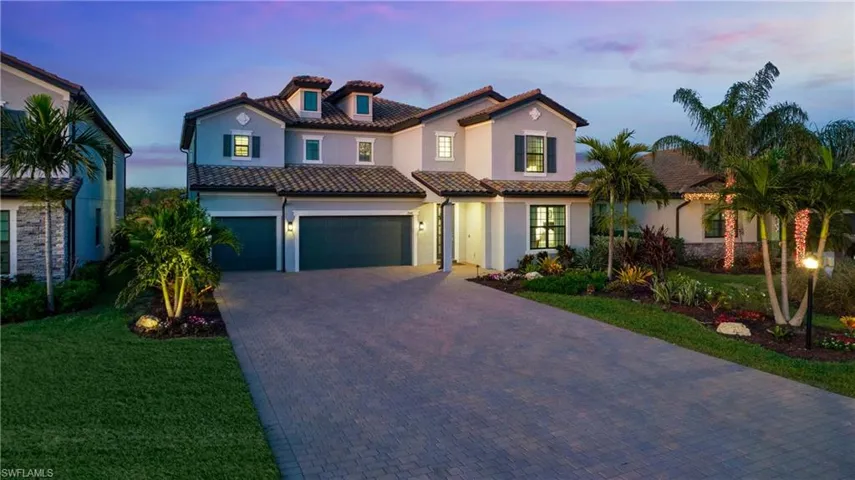 Mediterranean / spanish house with a lawn and a garage