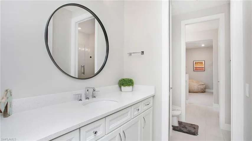Bathroom with tile patterned floors, vanity, and toilet