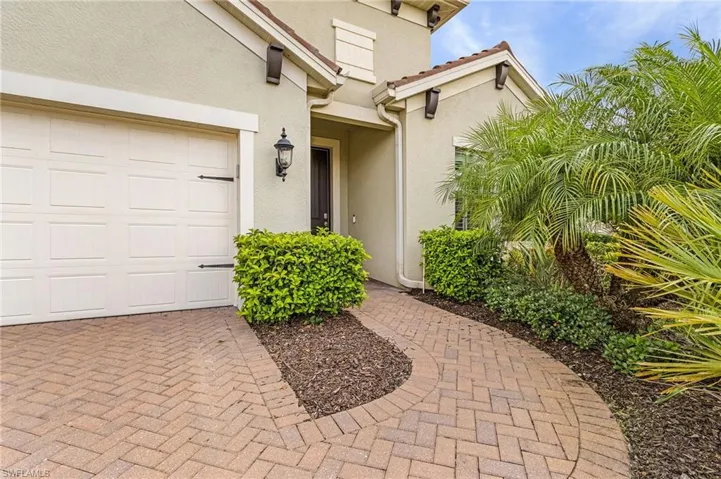 Doorway to property with a garage