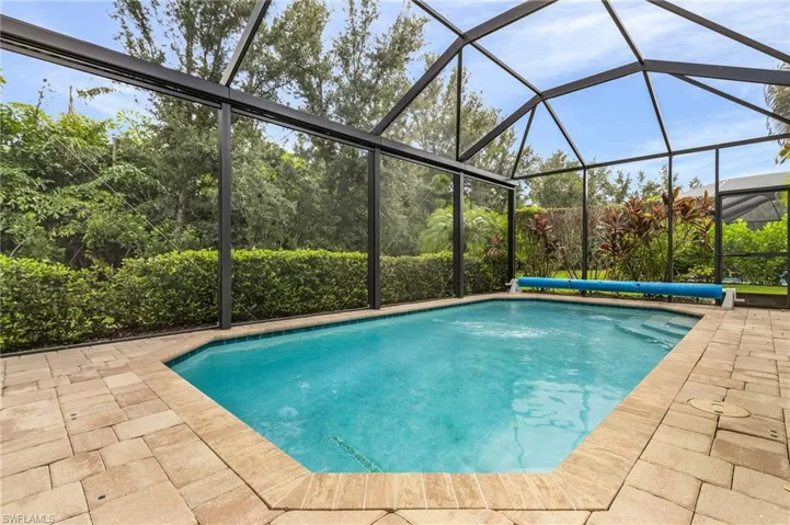 View of pool featuring a patio area and a lanai