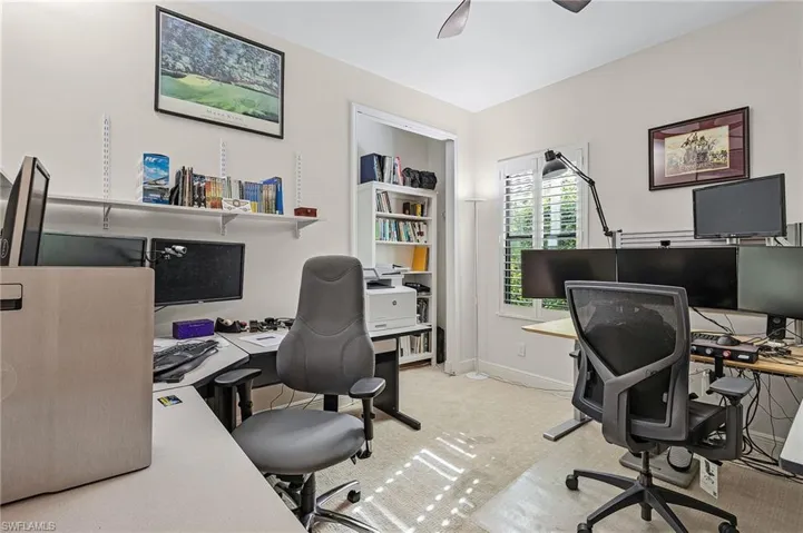 Office space with ceiling fan and light colored carpet