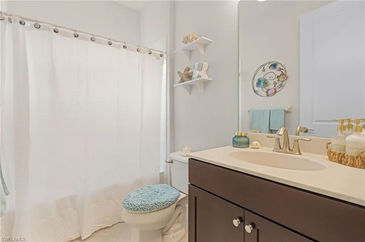 Bathroom featuring tile flooring, toilet, and vanity