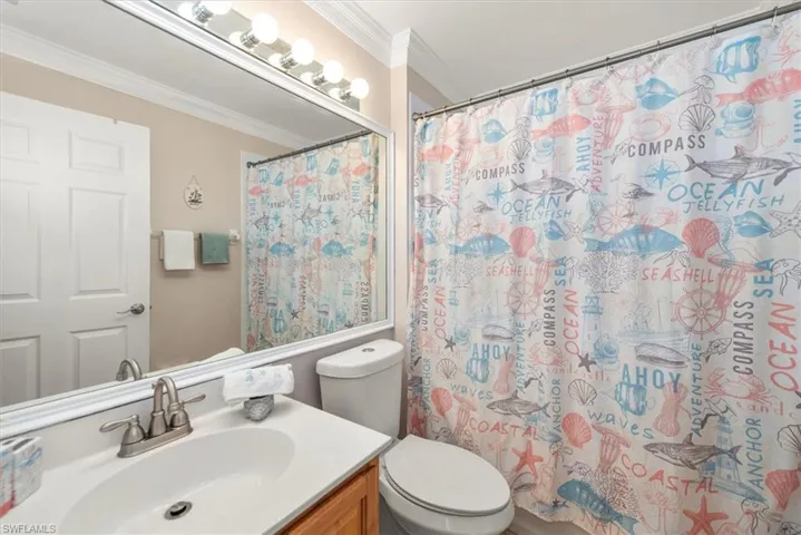 Bathroom featuring ornamental molding, vanity, and a shower with curtain