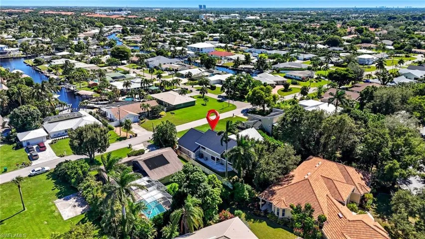 Aerial view of a residential neighborhood with numerous homes featuring a variety of architectural styles and roof types