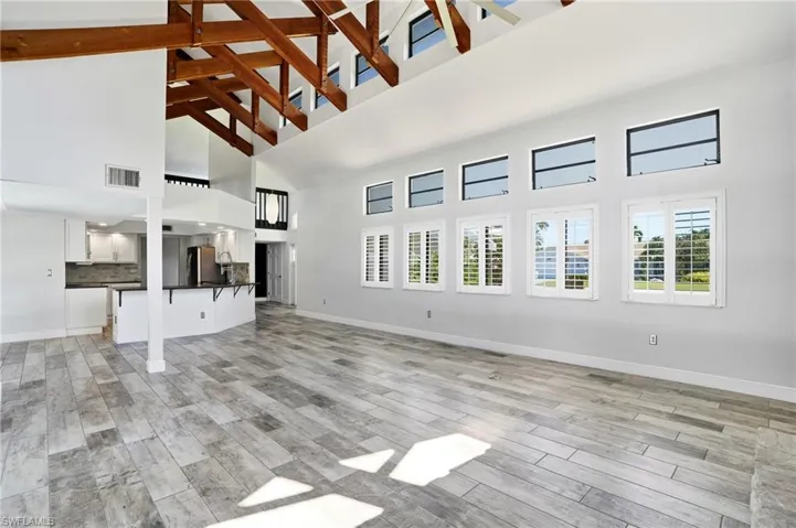 Soaring vaulted ceiling with exposed wood beams