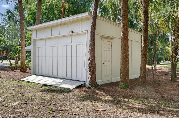 Additional storage building with garage door.