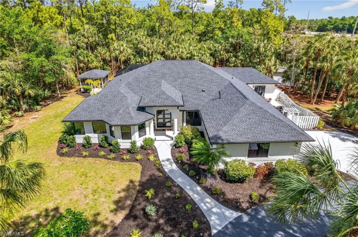 Lushly landscaped, new roof, new impact doors, new everything...Welcome Home!