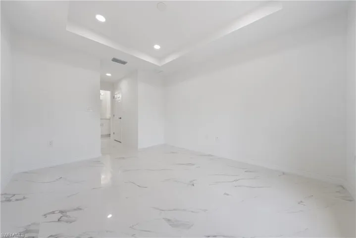 Unfurnished room with recessed lighting, visible vents, baseboards, and marble finish floor