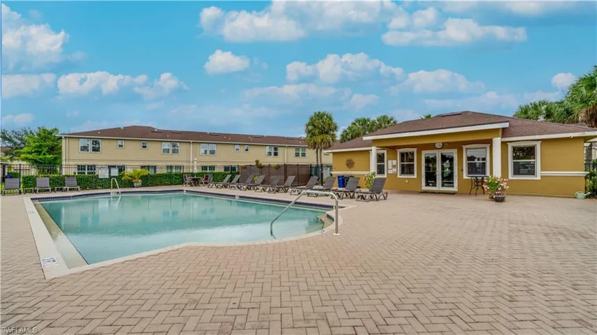Community pool with a patio area and french doors