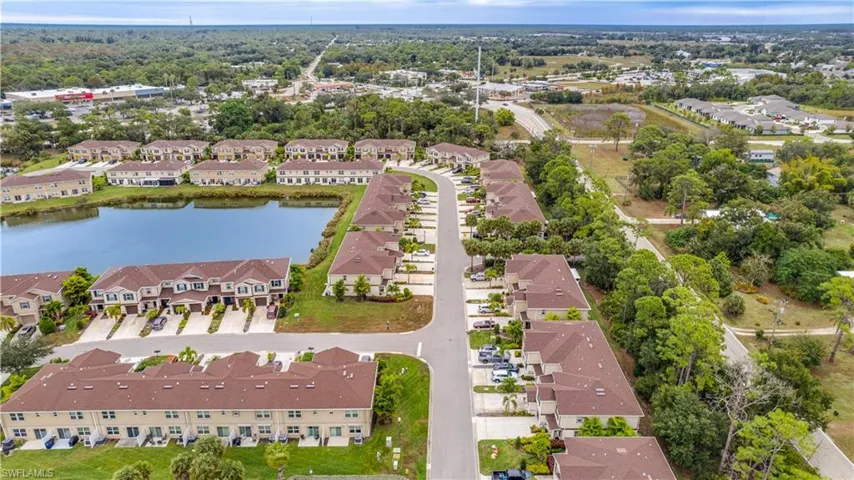 Aerial view of property's location featuring nearby suburban area and a nearby body of water