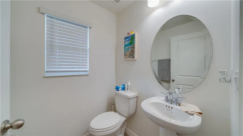 Half bathroom with a sink and toilet