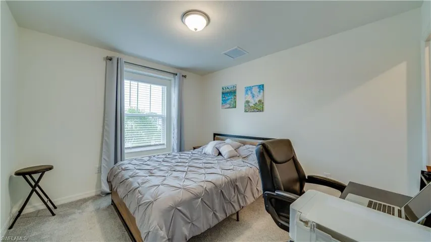 Carpeted bedroom with baseboards