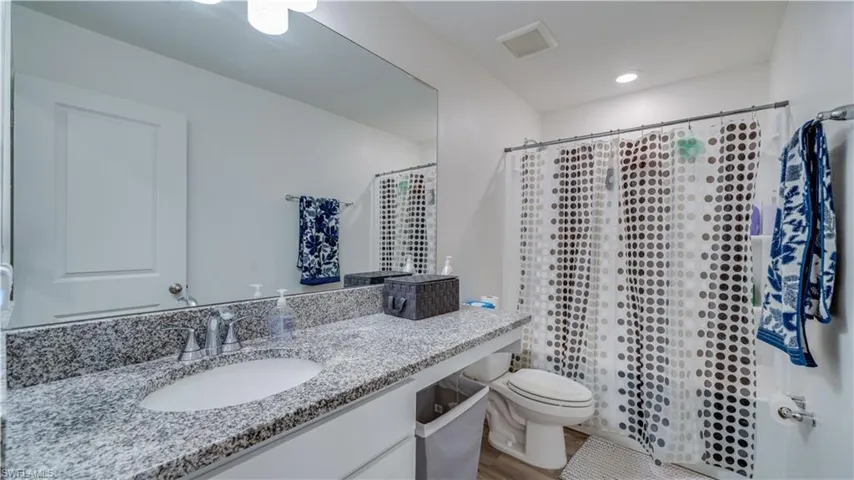 Bathroom featuring vanity and a shower with shower curtain