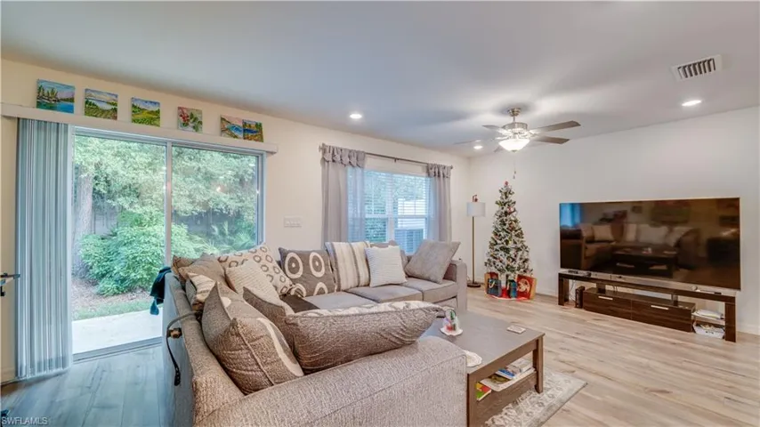 Living area with wood finished floors, recessed lighting, and ceiling fan