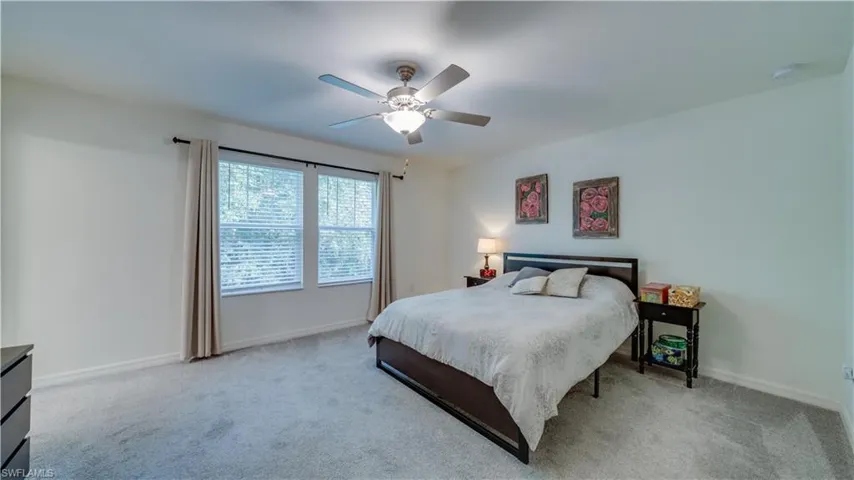 Bedroom featuring light carpet and ceiling fan