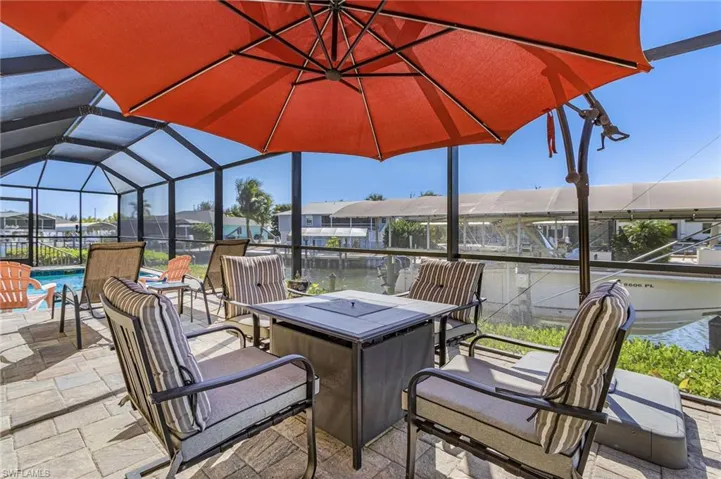 Pool and screened lanai overlooking the boat lift, dock, and canal with quick Gulf access.