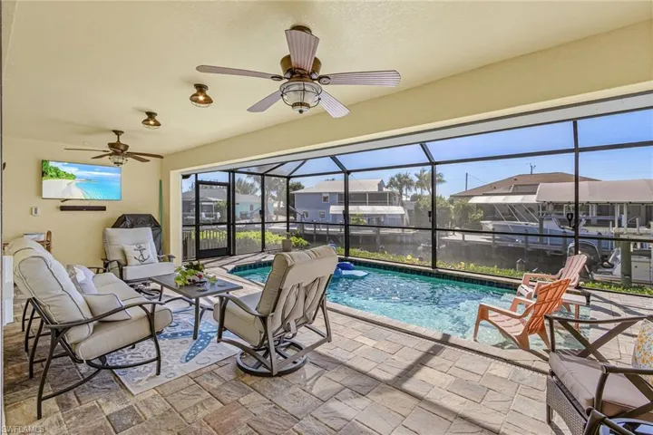 Covered patio with an electric hurricane roll down screen.