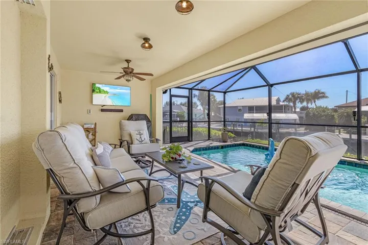 Covered area outside of the great room with lots of room to relax in the lanai with electric hurricane screens.