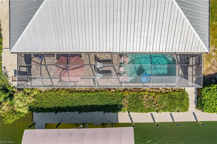 Aerial of the south of the home, dock, and lift.