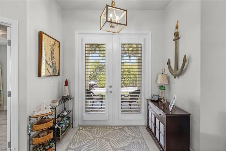 Hurricane French doors in the Entry with custom Plantation Shutters for privacy.