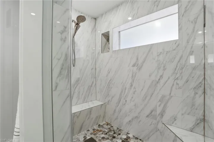 primary bath with window in shower
