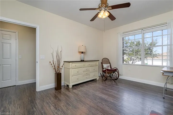 Living area featuring dark hardwood / wood-style floors and ceiling fan
