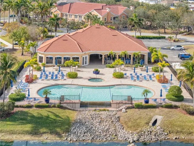 View of pool featuring a lawn, a patio, and a water view