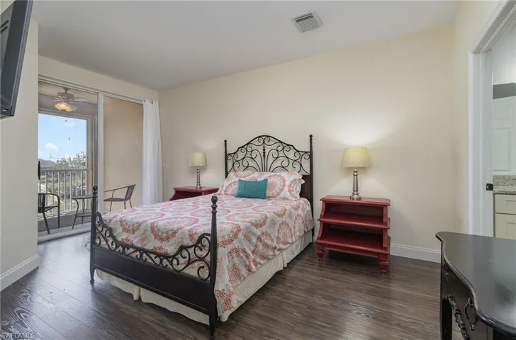 Bedroom featuring dark wood-type flooring and access to exterior