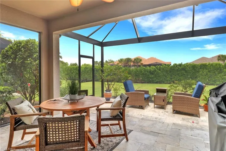 View of patio featuring a lanai, an outdoor hangout area, and grilling area with a ceiling fan