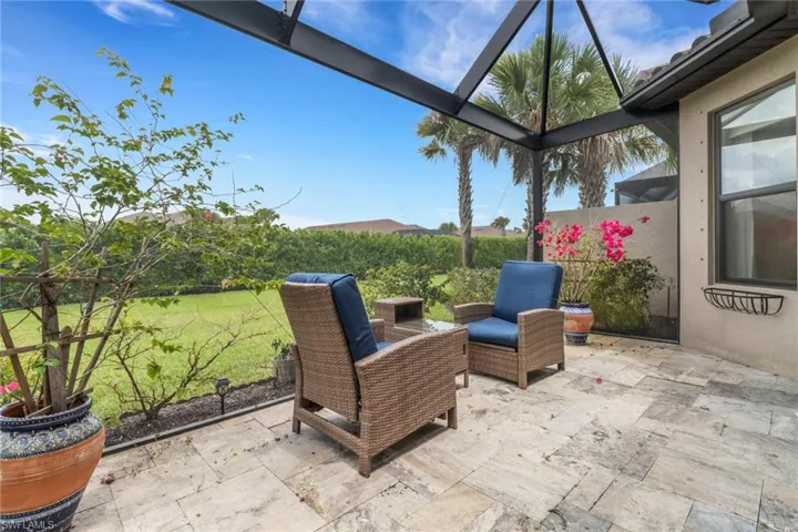 View of patio featuring a lanai
