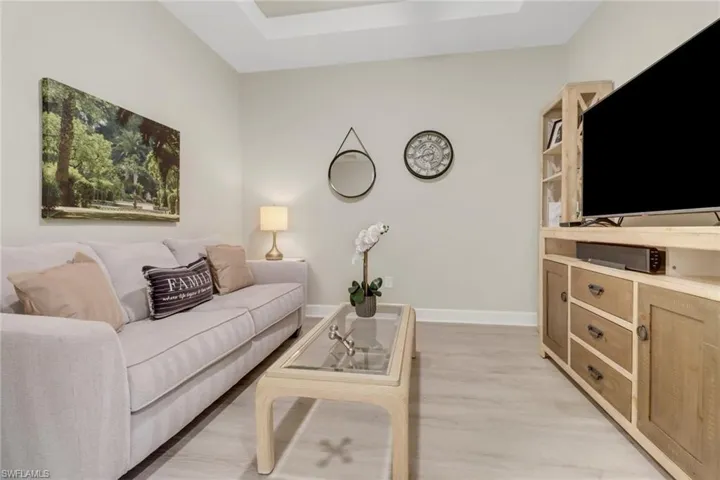 Den with pocket doors, light wood-style floors and tray ceiling w/fan.  Sleeper sofa provides additional sleeping area.