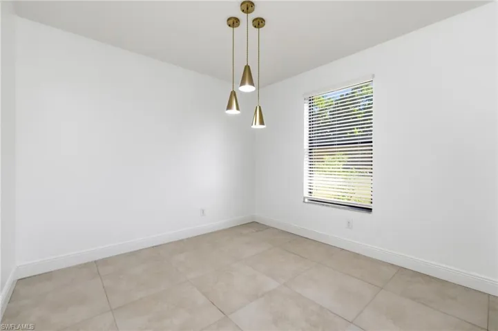 Unfurnished room with light tile patterned floors