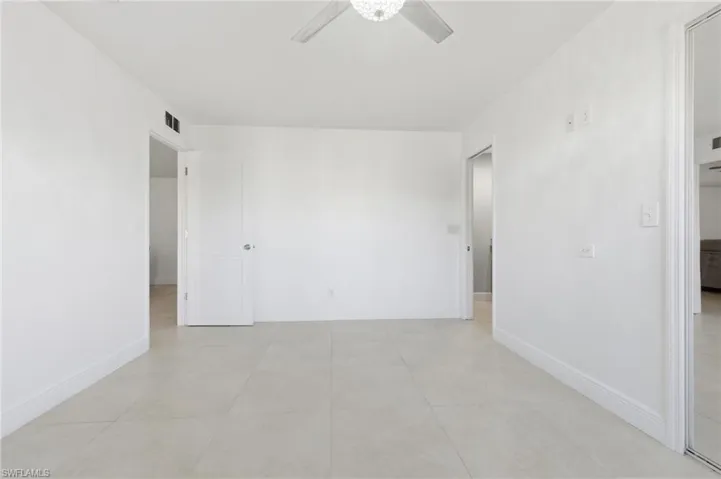 Unfurnished room with a ceiling fan and light tile patterned flooring
