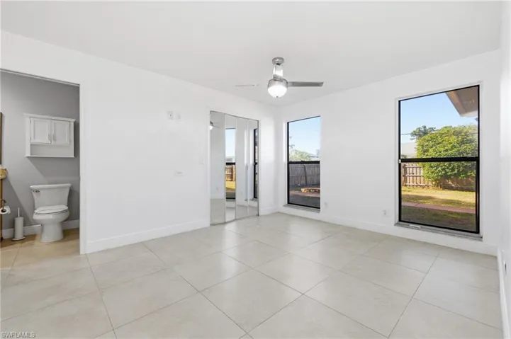 Empty room featuring light tile patterned floors and a ceiling fan