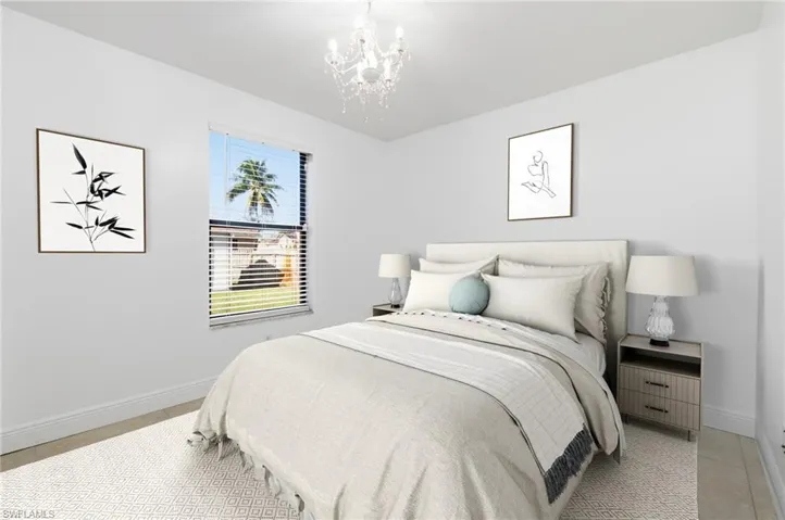 Bedroom with baseboards and a chandelier