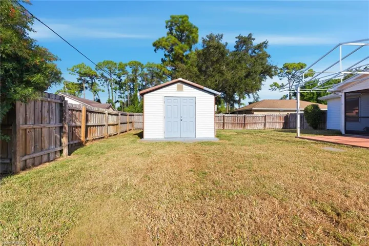 Fenced backyard with a storage unit
