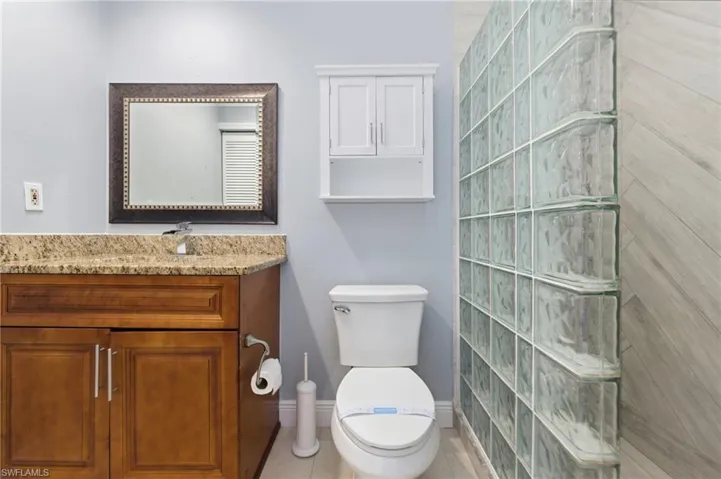 Full bath with vanity and tiled shower