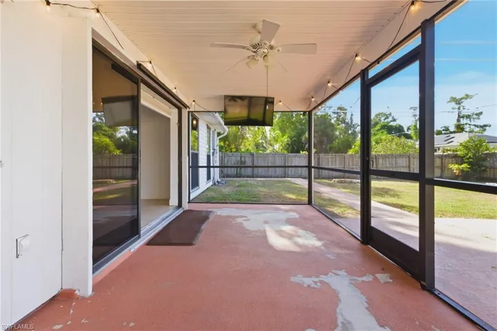 Unfurnished sunroom featuring ceiling fan
