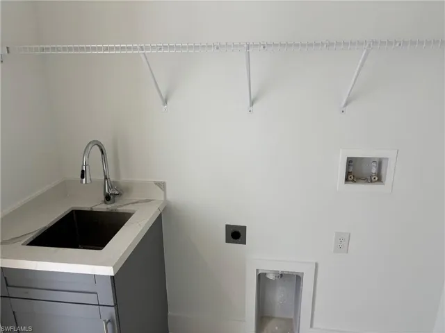 Laundry room with hookup for an electric dryer and hookup for a washing machine