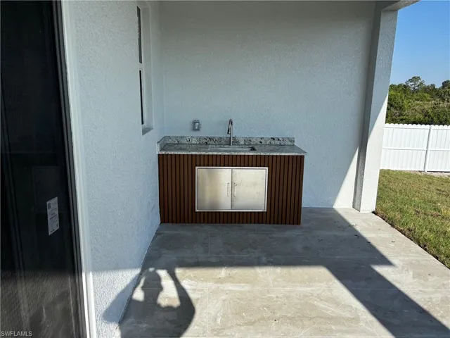 Exterior view of a sink and stucco siding