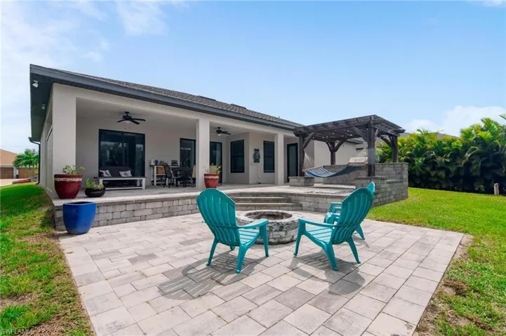 View of patio / terrace with a fire pit, a pergola, and ceiling fan
