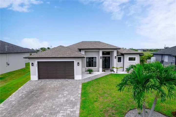 2019 built home with a garage and a front lawn