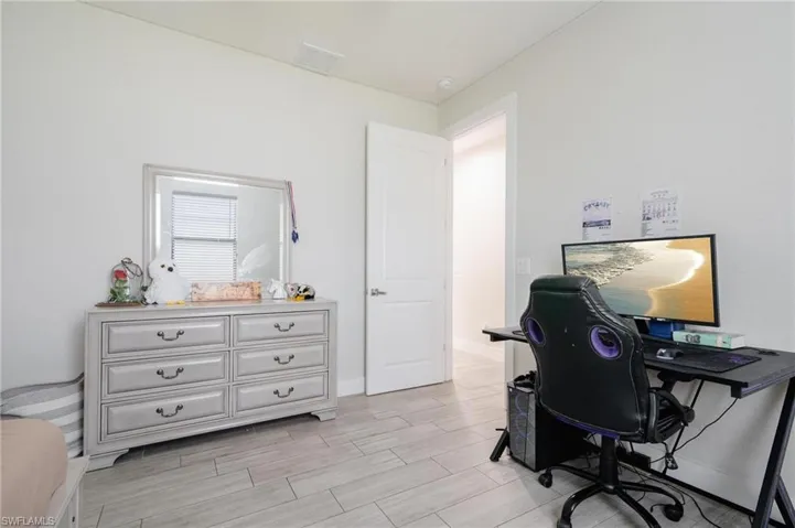 Home office with light hardwood / wood-style floors