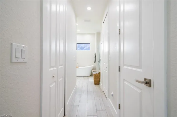 Hallway with light tile patterned floors